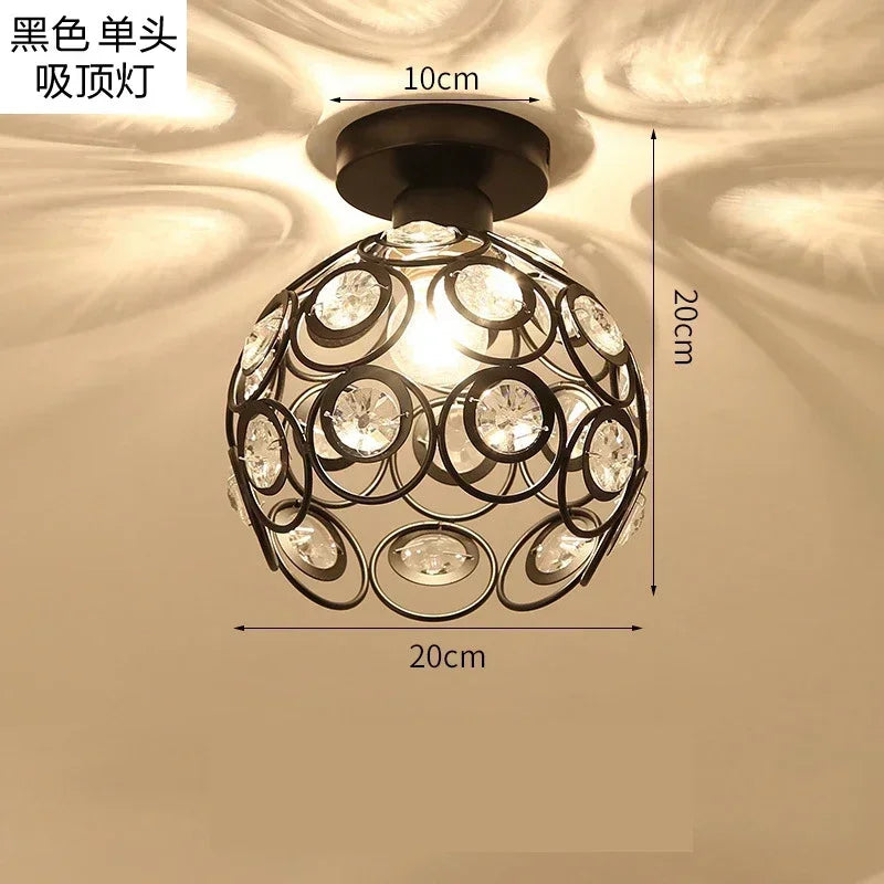 Black single bulb chandelier lamp with crystal accents and a modern design.