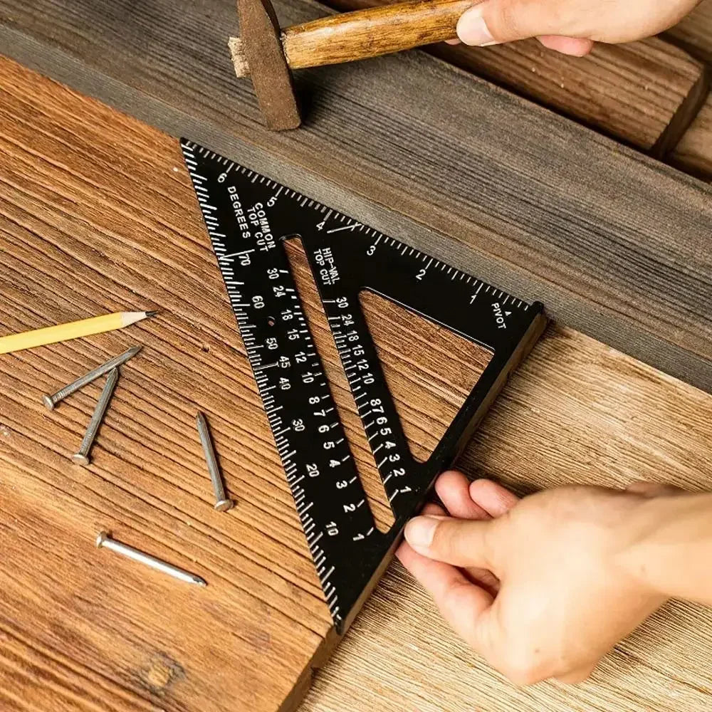 A hand is using a precision triangle square ruler for woodworking on a wooden surface.