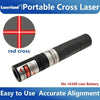 A black portable cross laser module with a red cross target visible on the end.