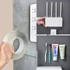 A hand is applying heavy-duty double-sided acrylic adhesive tape to a wall, next to a white Wi-Fi antenna mount.