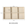 A rectangular beige plush velvet jewelry storage tray divided into six compartments.