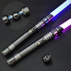 A close-up view of an RGB LED lightsaber with a metallic hilt and glowing blue and purple blade.