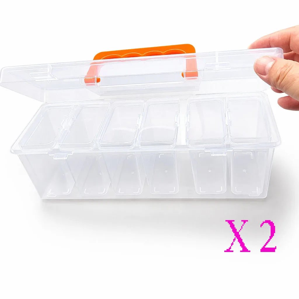 A hand holds a clear, multi-compartment plastic storage box with an orange lid and multiple transparent compartments inside.