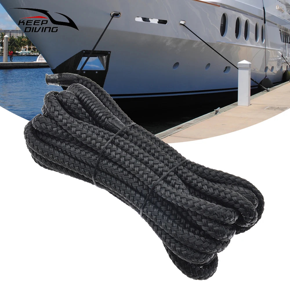 A thick black heavy duty double braid docking rope coiled and laid out for use.