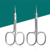 A pair of precision stainless steel cuticle and nail clippers shown against a teal background.