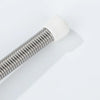 A close-up view of a white decorative iron spring door stopper.