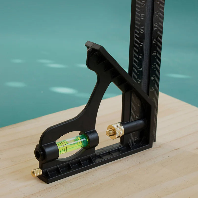 A black precision measuring tool set with a graduated scale and a cylindrical liquid container resting on a wooden surface.