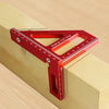 A red precision aluminum miter triangle layout tool is shown resting on a wooden surface.