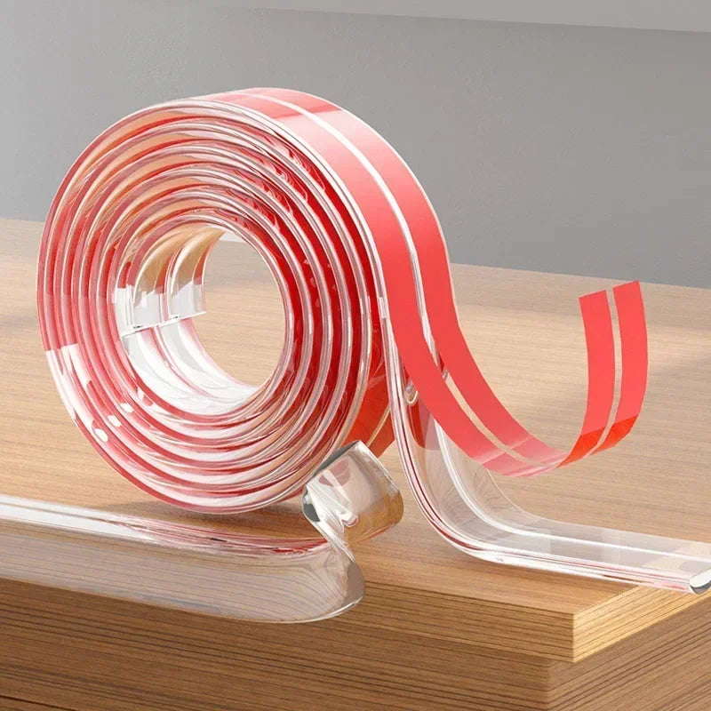 Roll of transparent pink and clear PVC baby safety edge guards on a wooden surface