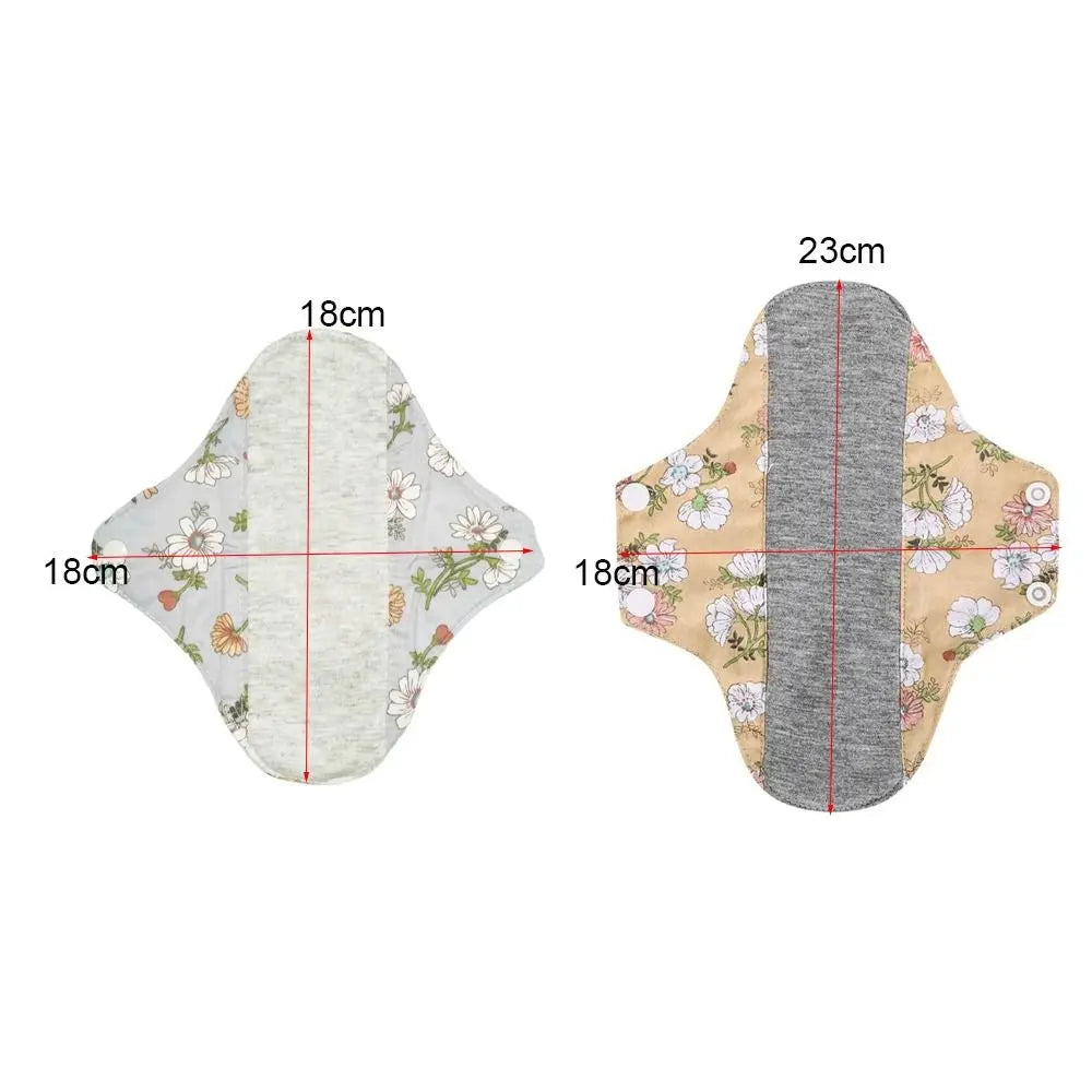 Reusable absorbent sanitary cloth pads shown flat with dimensions 18cm by 23cm