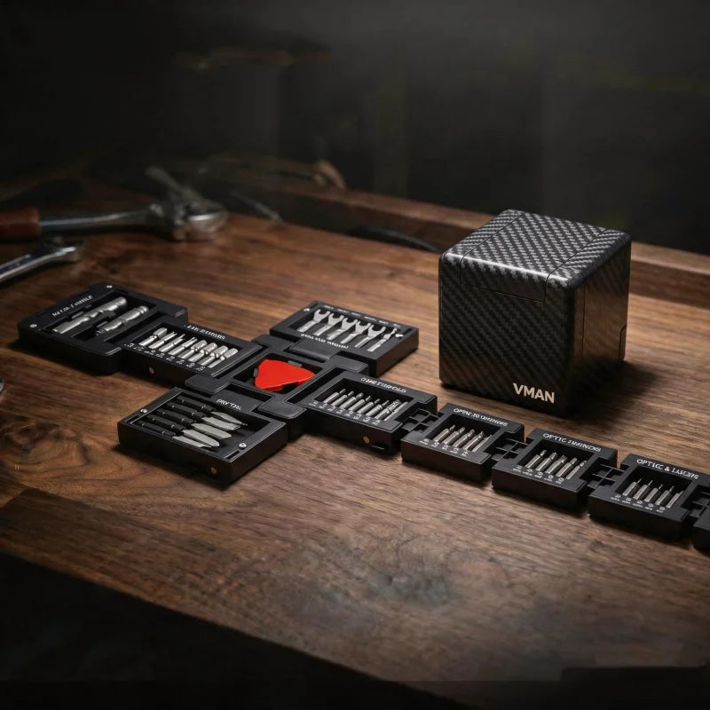 A black magnetic screwdriver set with dual handles is displayed on a wooden surface next to its packaging box.