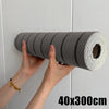 Hands are pulling a roll of gray self-adhesive wood grain wall panels, measuring 40x300cm.
