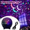 A purple galaxy projection night light sphere with a cord, illuminating stars and a crescent moon.