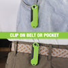 A lime green folding utility knife is clipped onto a belt or pocket of a denim shirt.