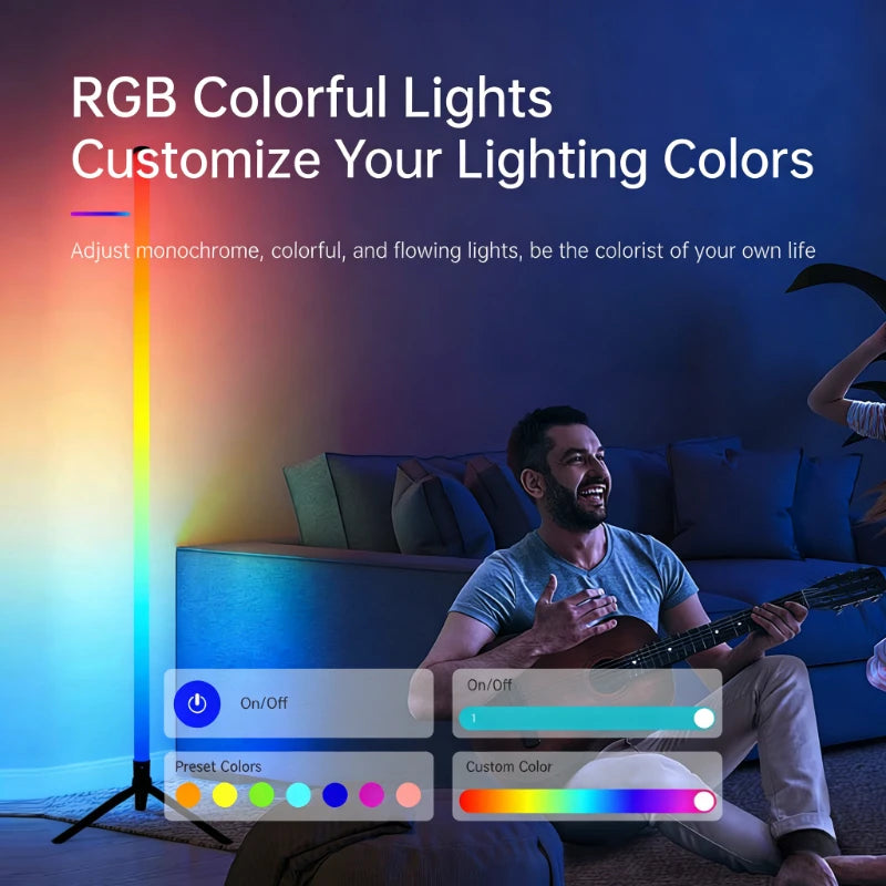 A man is sitting on a couch next to an RGB colorful floor lamp that illuminates the room.