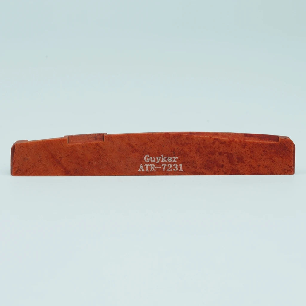 A wooden guitar bone bridge saddle with the name Guyker ATR-7231 engraved on it.