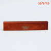A rectangular piece of reddish-brown acoustic guitar bone bridge saddles labeled Guykor 5560