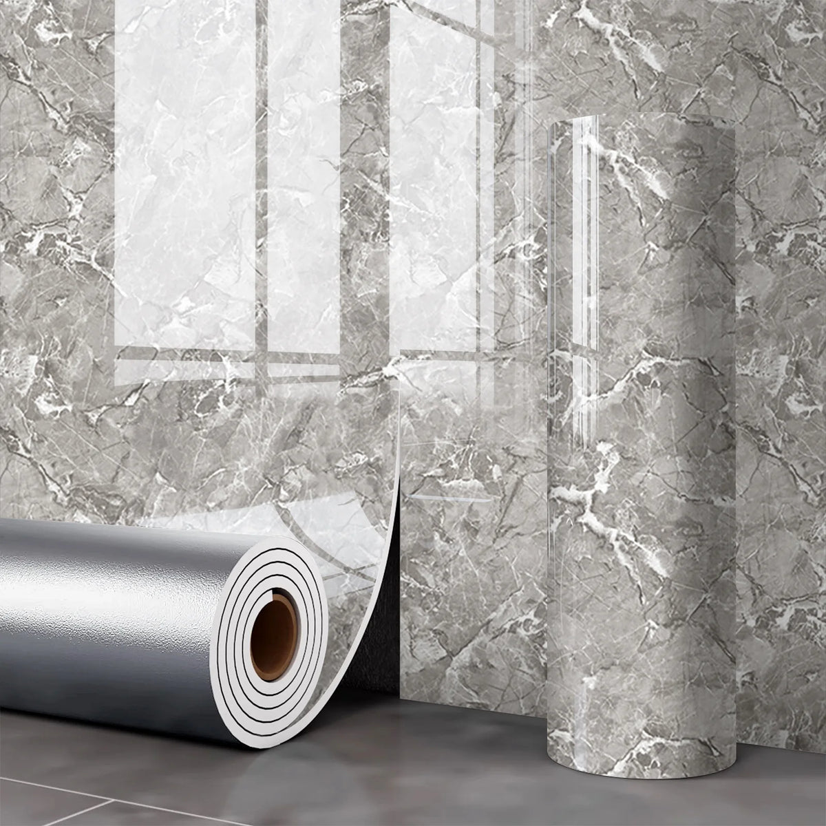 Roll of silver marble wall decals against a gray marbled bathroom or kitchen wall.