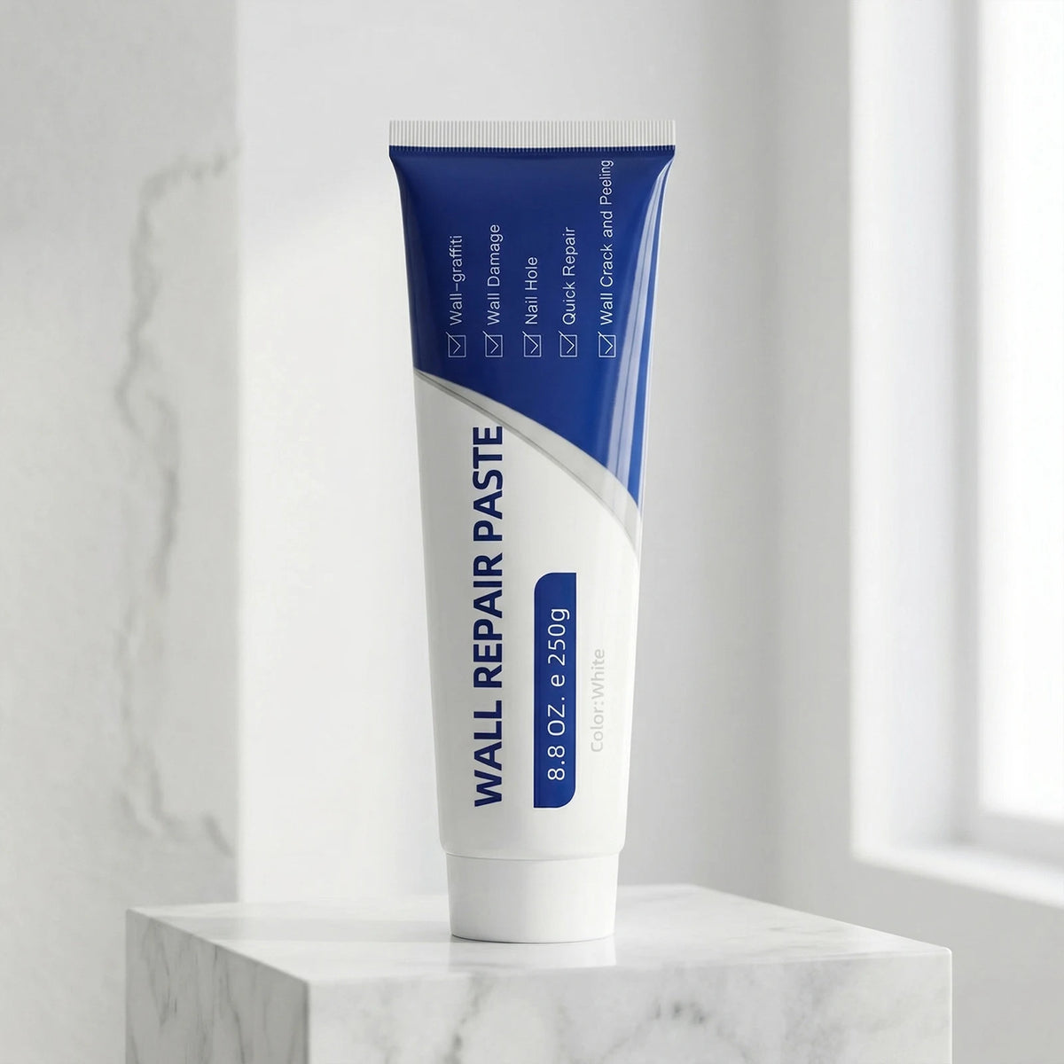 A tube of Wall Repair Paste for drywall repair and pegging is displayed on a white marble surface.