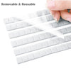 A hand is holding a sheet of removable and reusable nail glue clay, showing its thin, translucent texture.