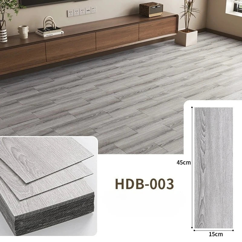 Gray wood grain floor tiles showing a rectangular tile and its thickness.