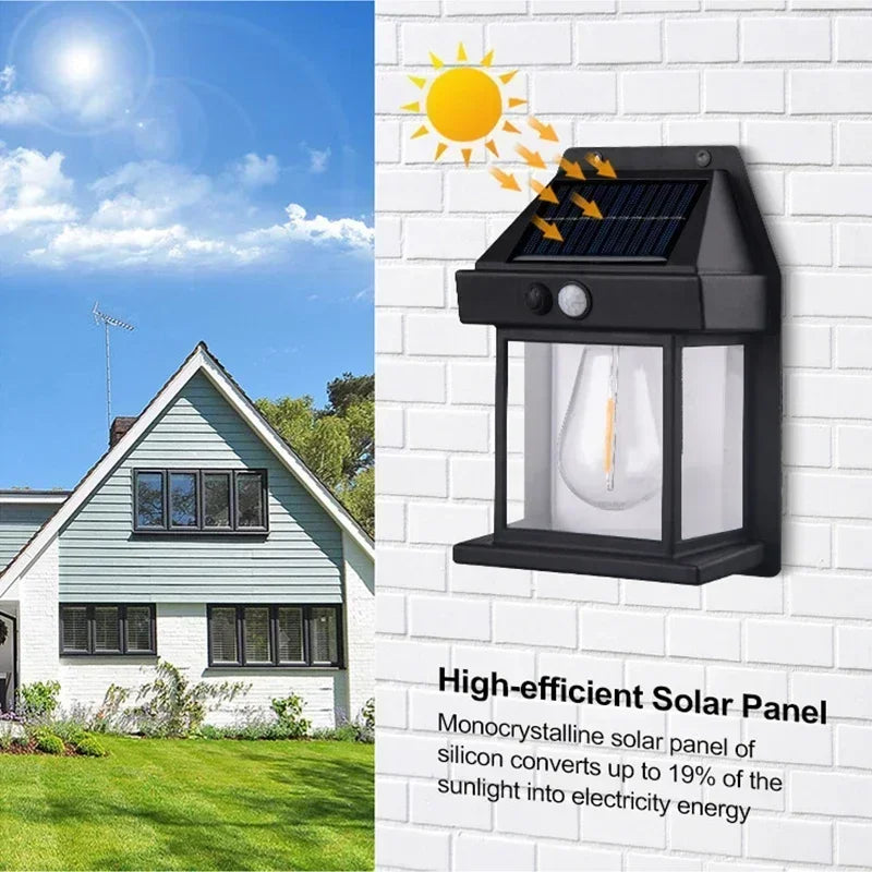 A black solar panel outdoor wall light is shown mounted on a white brick wall with sunlight hitting the panel.