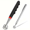A silver telescopic magnetic gripper tool with a black handle and red accent is shown against a white background.
