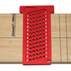A red precision T-square ruler with numbered markings is shown resting on a wooden surface.