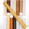 A close-up view of various rolls of wood grain vinyl wall contact paper displayed in a vertical arrangement.