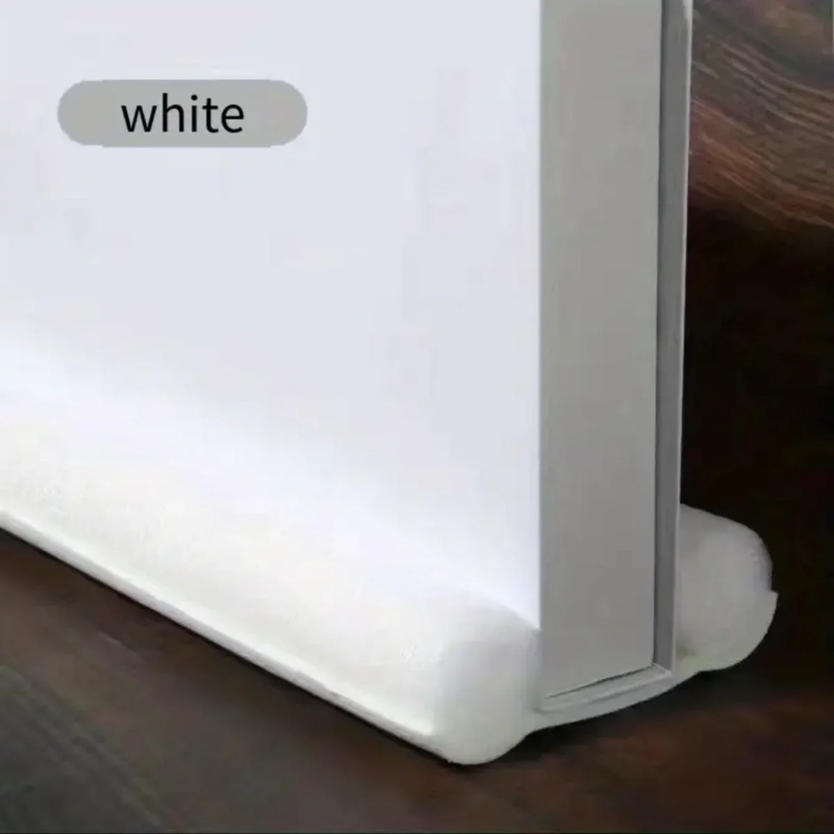 A white door and window sealing strip is shown resting on a dark wooden surface.