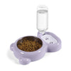 Set de dispensador automático para alimentar mascotas de color púrpura con botella de agua transparente y cuenco para comida.
