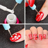A set of multi-use sculpting and decoration tools used to apply red nail polish with white polka dots onto fingernails.