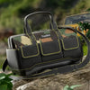 A black and olive green plastic reinforcement kit toolkit bag with a handle resting on a rock outdoors.