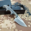 A minimalist fixed blade utility knife with a dark handle and silver blade is displayed in its box.
