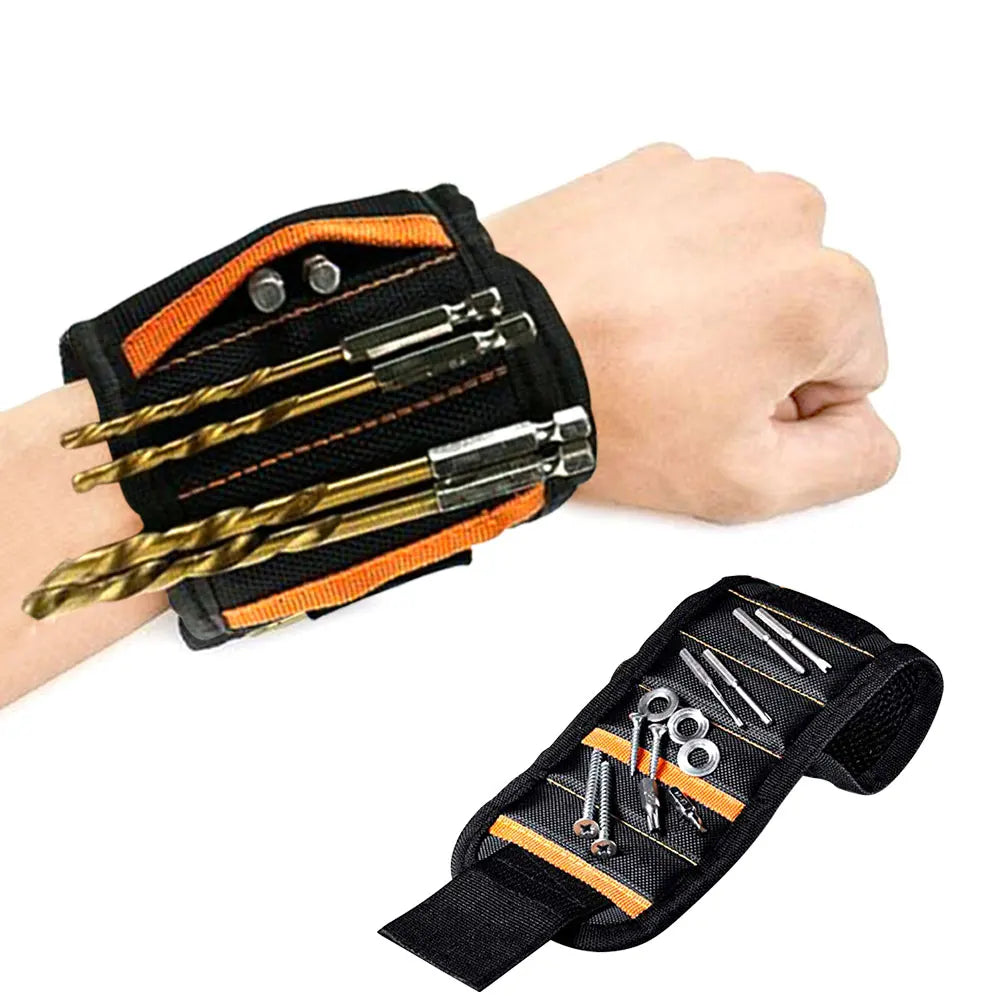 A hand is holding a black magnetic wrist strap tool with gold and orange accents, showing various tools attached.