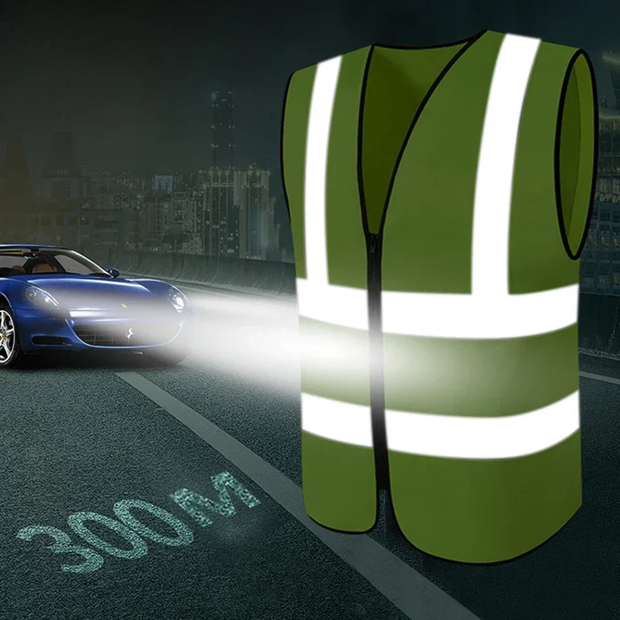 A bright green high-visibility reflective safety vest is shown on a road with a blue car in the background.