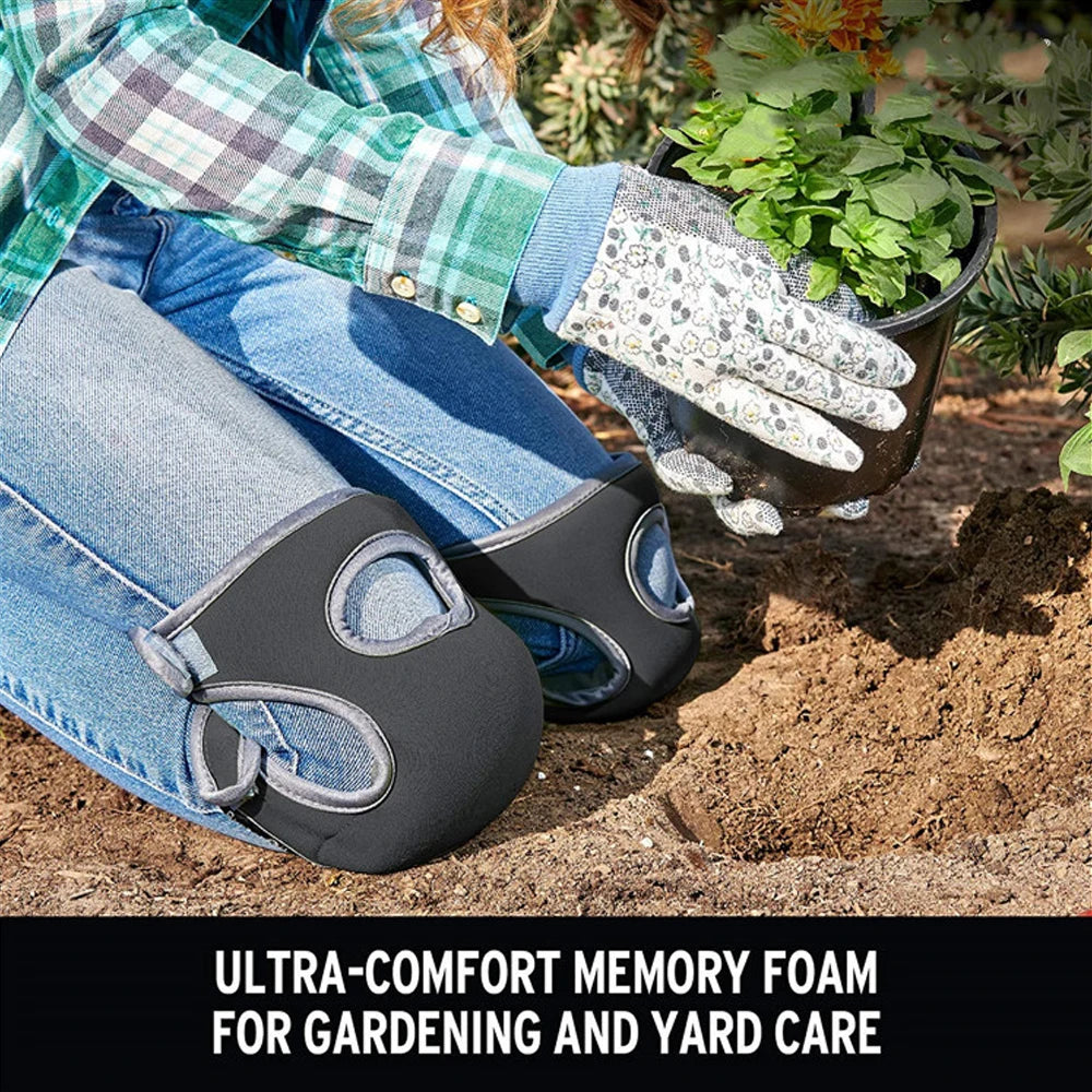 A person wearing denim jeans is using black memory foam knee pads to protect their knees while gardening.