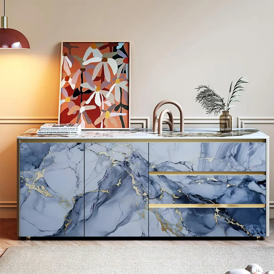 A modern kitchen cabinet featuring blue marble with gold veining and a light countertop.