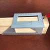 A light blue precision angle ruler is shown resting on a wooden surface, demonstrating its measurement markings.