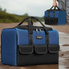 A blue and black heavy duty multi-compartment tool organizer bag is shown being held by a hand.