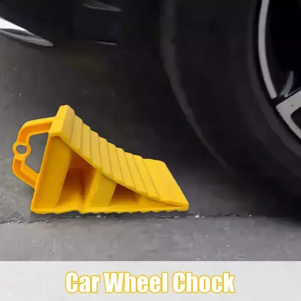 A yellow heavy duty car wheel chock anti-slip tire stop block is shown on a dark surface.