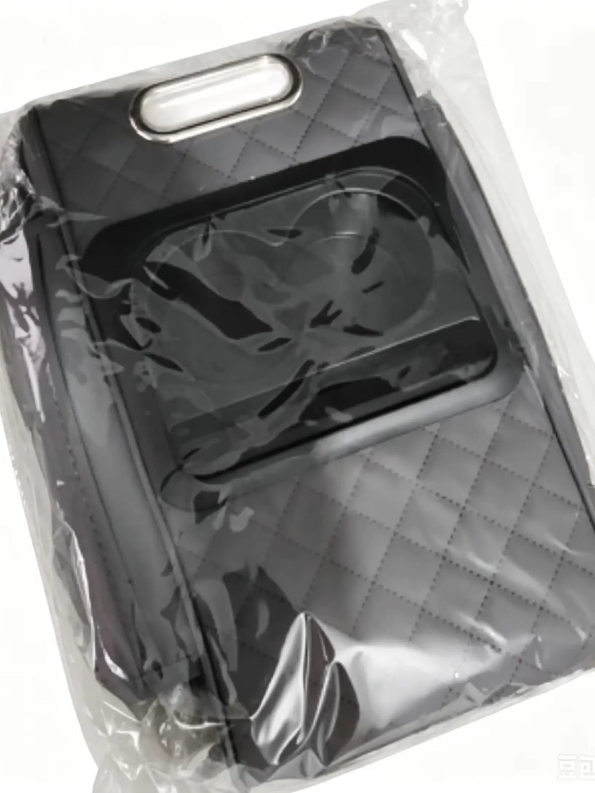 A black car armrest cushion with cup holders is visible inside clear plastic packaging.