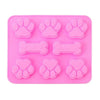 Un ensemble de moules en silicone rose avec diverses formes de pattes et d'os de chien.