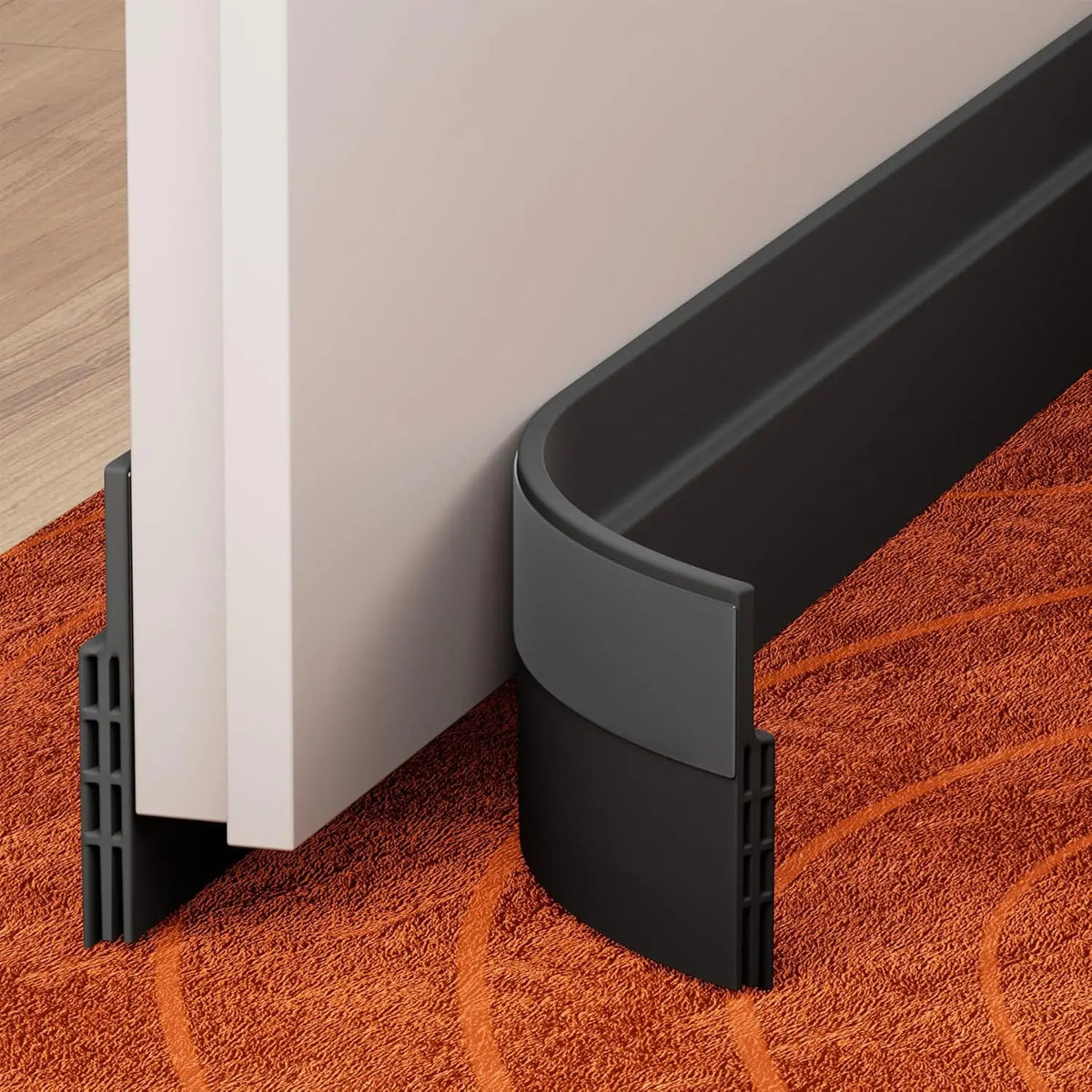 A black door draft stopper weather stripping seal is shown installed on a white door frame resting on an orange carpet.