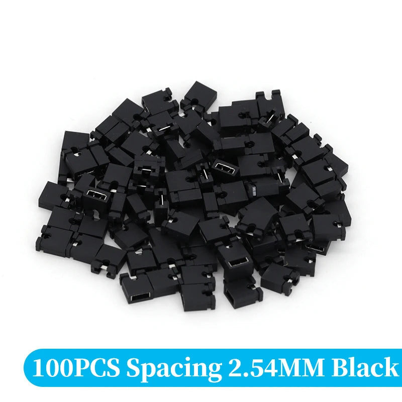 A pile of 100 black spacing jumper cap connectors with a 2.54mm pitch.