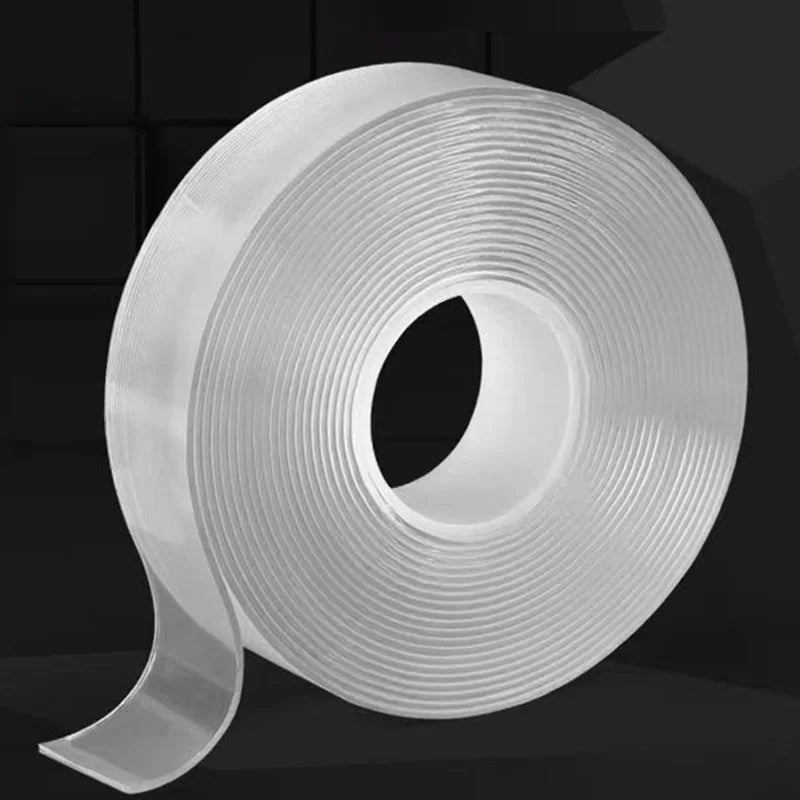 Roll of clear heavy duty double-sided reusable adhesive tape viewed from above