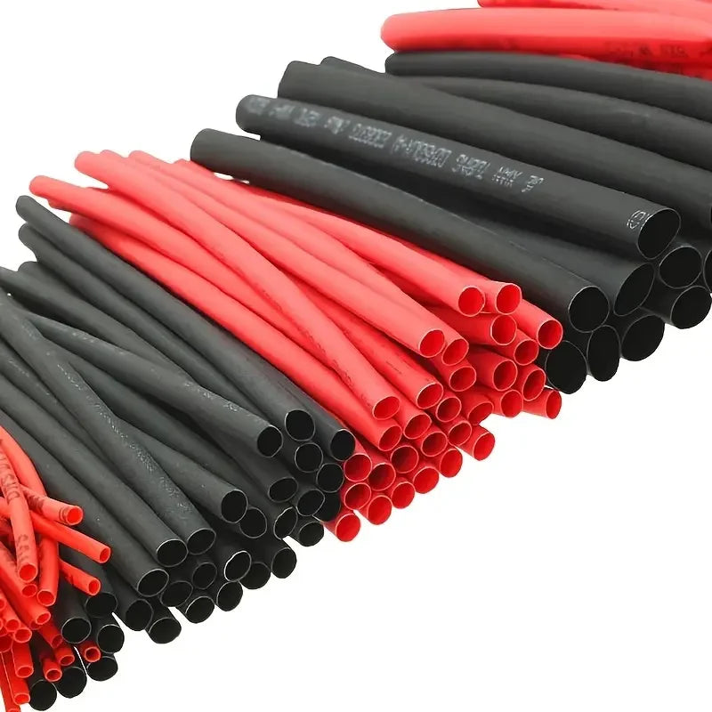 A collection of heat shrink tubing in red and black colors arranged diagonally.