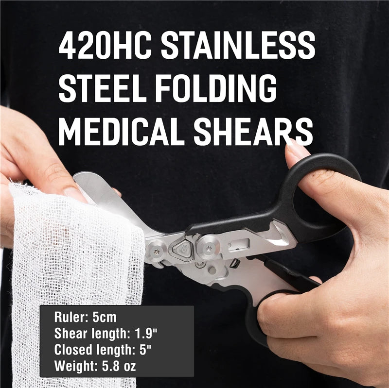 A hand holds a 420HC stainless steel folding medical shear with a ruler for scale.