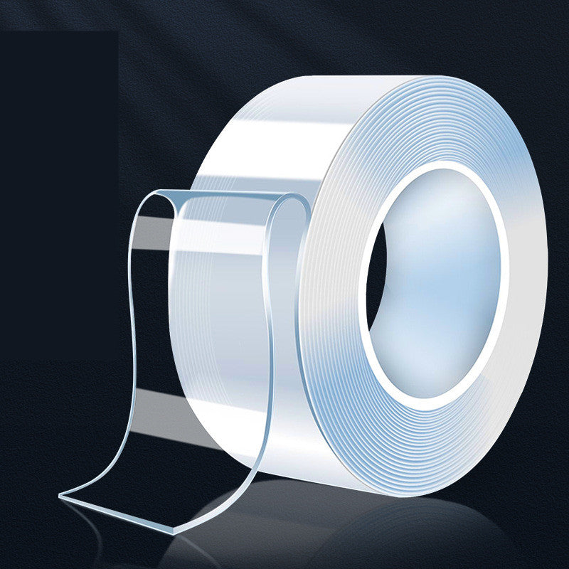 Roll of clear double-sided nano adhesive tape shown on a dark surface.
