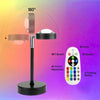 A multi-color LED sunset projector night light with a stand and remote control showing 180 degree light projection.